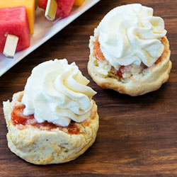 Half portion of scone with jam and cream ready to eat thumbnail